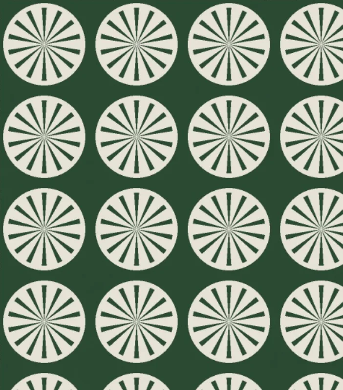 An art deco fan motif in cream on bottle green
